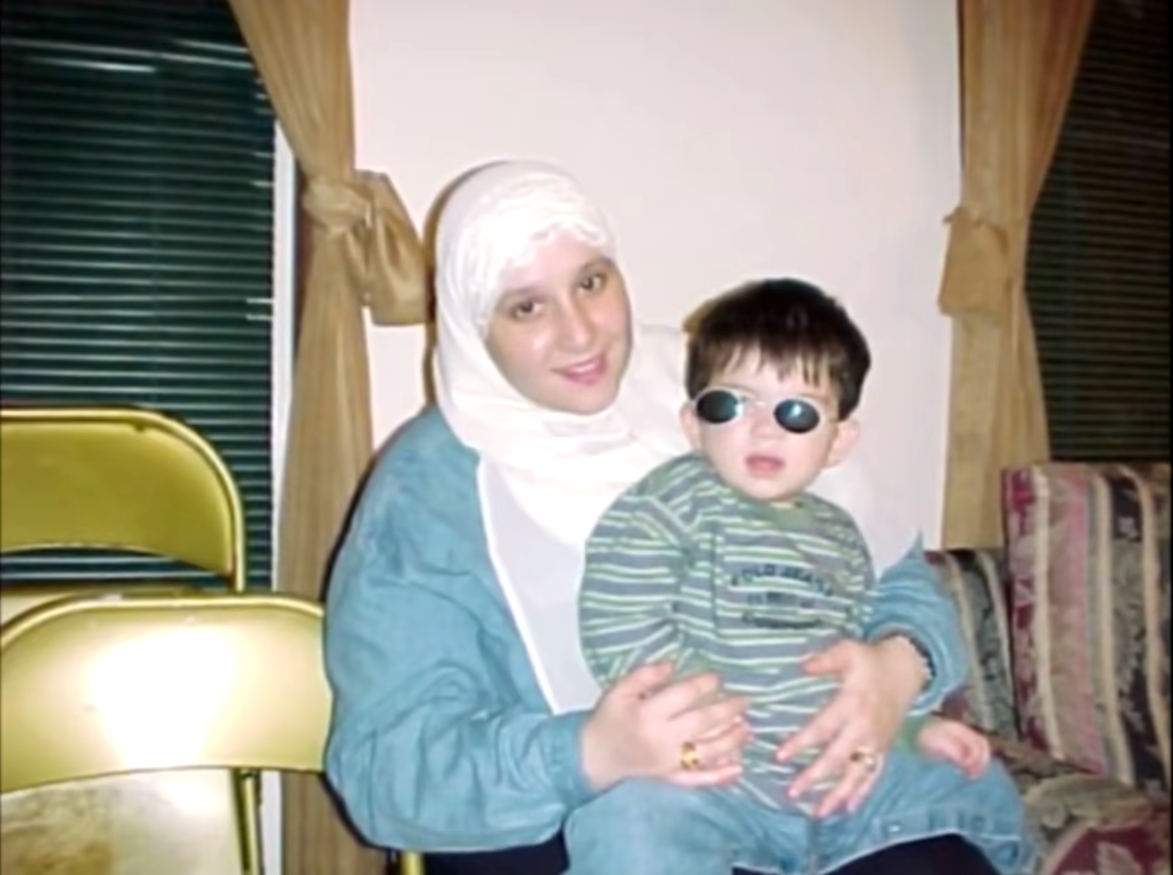 me as a toddler on my mom's lap wearing cool shades